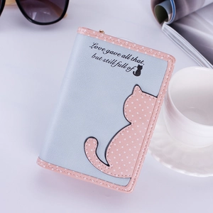 Detail of blue and pink bifold wallet with cute cat motif and polka dot pattern detail