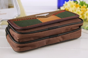 Detail view of the layered structure and striped flap of the nylon waist phone bag