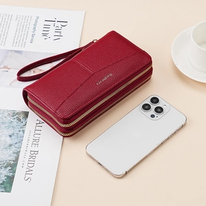 Dual zipper wallet in burgundy lychee leather shown with a smartphone for size reference