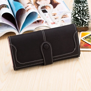Detail of long black pebble leather wallet with white stitching and pink interior lining