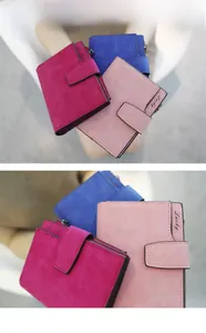 Detail of three matte flap wallets with Lucky lettering in rose, navy, and pink tones