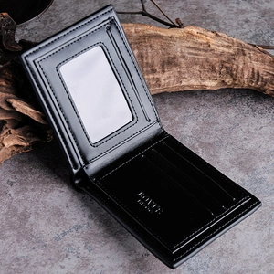 Detail view of men's black leather bifold wallet showing card slots and ID window