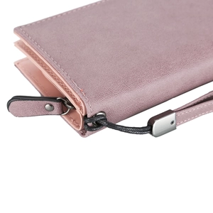 Detailed macro view of pink frosted faux suede texture and metal zipper with wrist strap