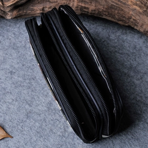 Detailed top view of a black multi-layer canvas waist bag with three zip pockets