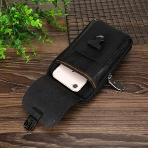 Detail of black nylon and PU leather tactical waist pouch with buckle and zipper closure