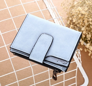 Detail of light blue frosted suede wallet with belt buckle and metal zipper close-up