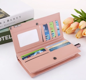 Detailed interior of a pink frosted faux leather long wallet with multiple card slots and zipper