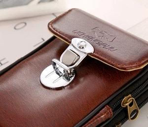 Detail view of brown PU leather men's belt pouch with double zippers and silver buckle