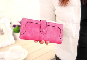 Detail of pink vintage frosted wallet with white stitching and single button buckle