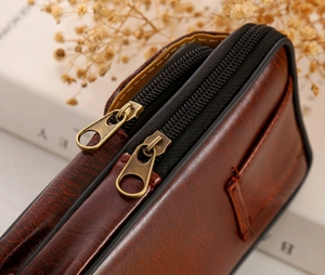 Detail shot of vintage dark brown PU leather waist bag with double zipper closures