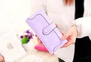 Detail of lavender frosted suede long wallet with black scalloped edge and snap closure