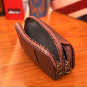 Brown lychee leather belt pouch with double zippers and orange stitching detail