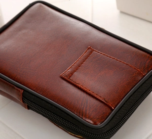 Detail of dark brown PU leather cell phone waist pouch with durable black zipper