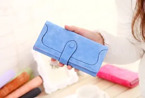 Detail of light blue matte long wallet with white stitching and snap closure