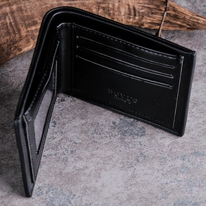 Detailed view of black bifold leather wallet interior with card slots and ID window
