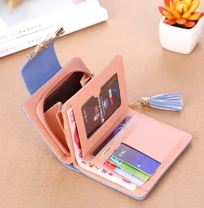 Detail showing pink and blue bifold wallet interior with card slots and tassel charm