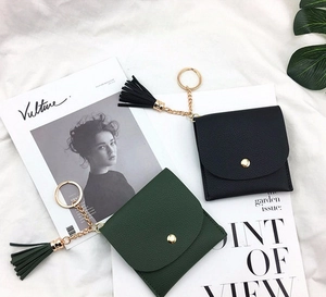 Mini pebbled leather coin purses in black and green with tassel keychains and snap closure