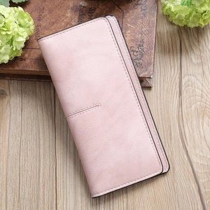 Close-up of pink leather long wallet showing fine grain texture and precise black edge stitching