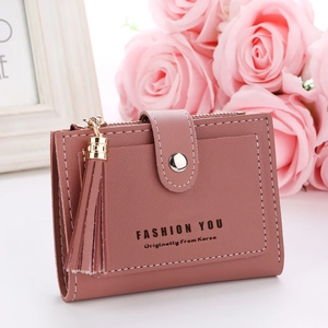 Close-up of pink short wallet with matte PU leather texture and stylish tassel detail