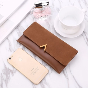 Brown frosted patchwork long wallet with V-shaped gold clasp on white marble background