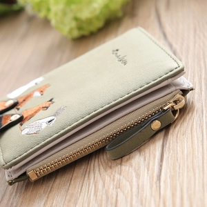 Detail of short bifold wallet featuring cute fox and rabbit embroidery on PU leather