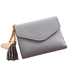 Gray lychee pattern wallet for women with heart pendant and tassel on white background