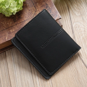 Macro shot of black bifold leather wallet with lychee texture and fine stitching detail