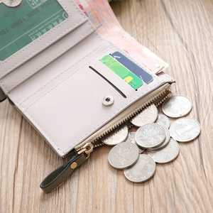 Close-up of foldable PU leather wallet showing multiple card slots and zip coin pocket