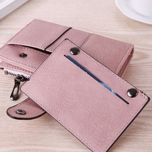 Detail view of mauve frosted leather wallet with functional card slots and metal snap closure