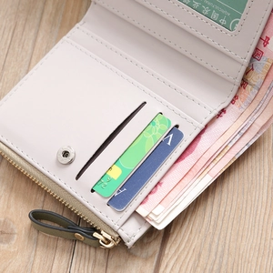 Close-up of compact inner card slots and gold zipper detail on beige women wallet