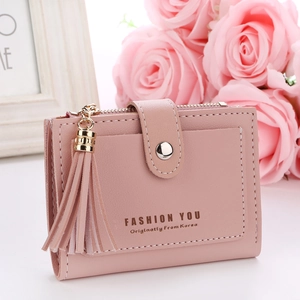 Pink women short wallet with tassel charm and button buckle against floral background