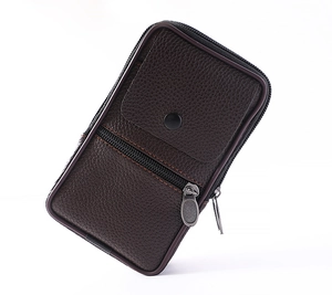 Detailed macro view of dark brown pebbled leather texture on vertical men's belt bag