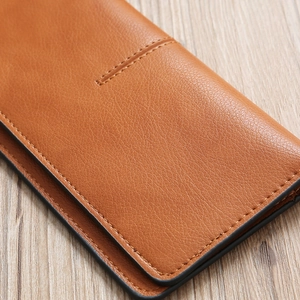 Detail shot of brown lychee grain leather wallet with precise stitching and edge oil finish