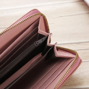Pink lychee texture wallet detail with multi-card slots and golden zipper interior