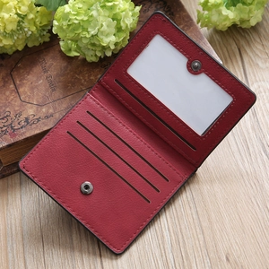 Detail view of burgundy leather wallet with card slots and transparent photo window