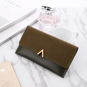 Close-up of trifold long wallet featuring matte brown suede and green leather with V-gold clasp
