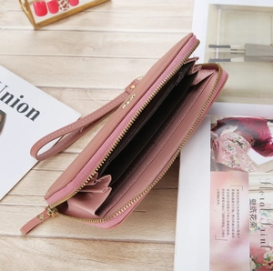 Detailed internal view of pink faux leather wallet with card slots and coin pocket