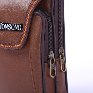 Vertical brown pebbled leather men's belt pouch with dual zippers and woven trim detail