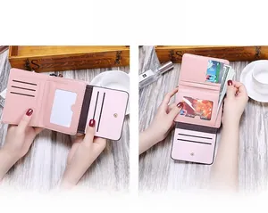 Pink tri-fold wallet detail showing multiple card slots and clear ID window for storage