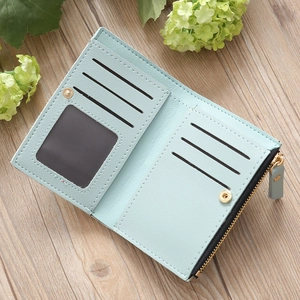 Detail view of mint green bifold wallet interior showing card slots and coin pocket