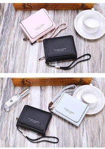 Detailed view of trifold women's wallets with wristlet and charm fashion embossed text