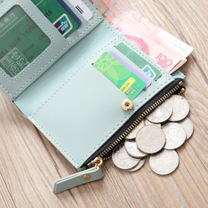 Detail view of mint green mini wallet showing card slots and zipper coin pocket