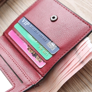 Interior detail of red leather wallet showing card slots and banknote compartment