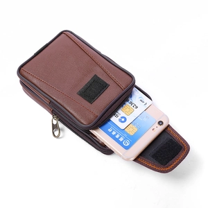 Detailed side view of brown textured leather waist bag with double zipper compartments
