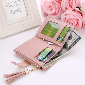 Pink bifold wallet detail showing multiple card slots and a clear ID window for storage