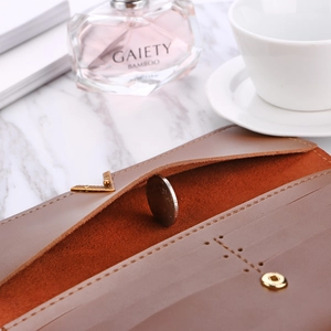 Macro shot of long frosted wallet interior showing golden V-buckle and coin storage