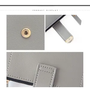 Detailed macro view of gray lychee leather texture and metal snap closure on a small wallet