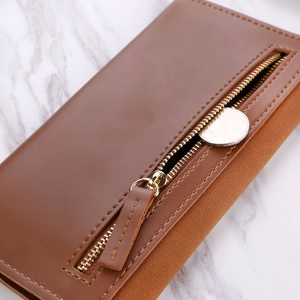 Close-up of brown long wallet with matte texture, gold zipper, and side coin pocket detail