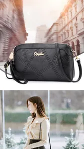 Detail of black crossbody bag with geometric quilted texture and gold metal logo accent