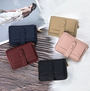 Close-up of assorted lychee texture leather wallets with snap buttons and side zippers